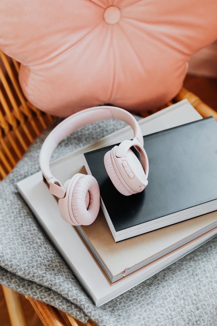 Headphones and a pile of books - audiobooks can be helpful if you wake up in the night and struggle to fall back asleep