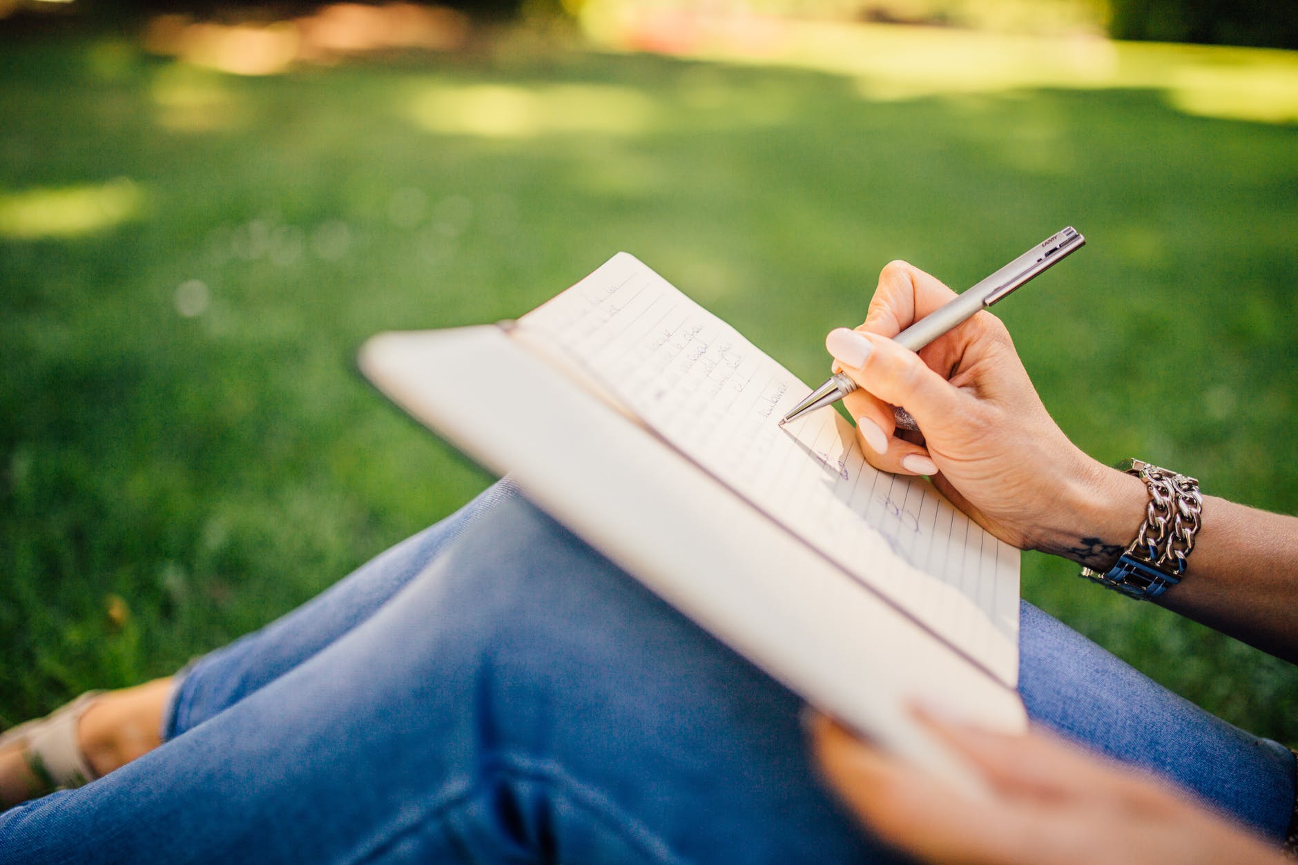 A woman writes up her goals for the coming year in her journal