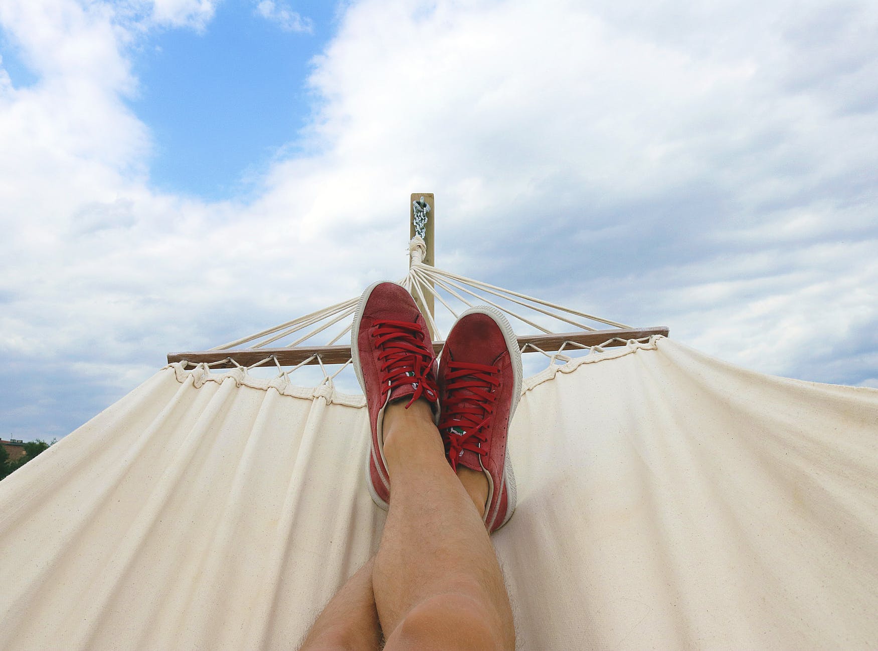 man relaxing on a hammock